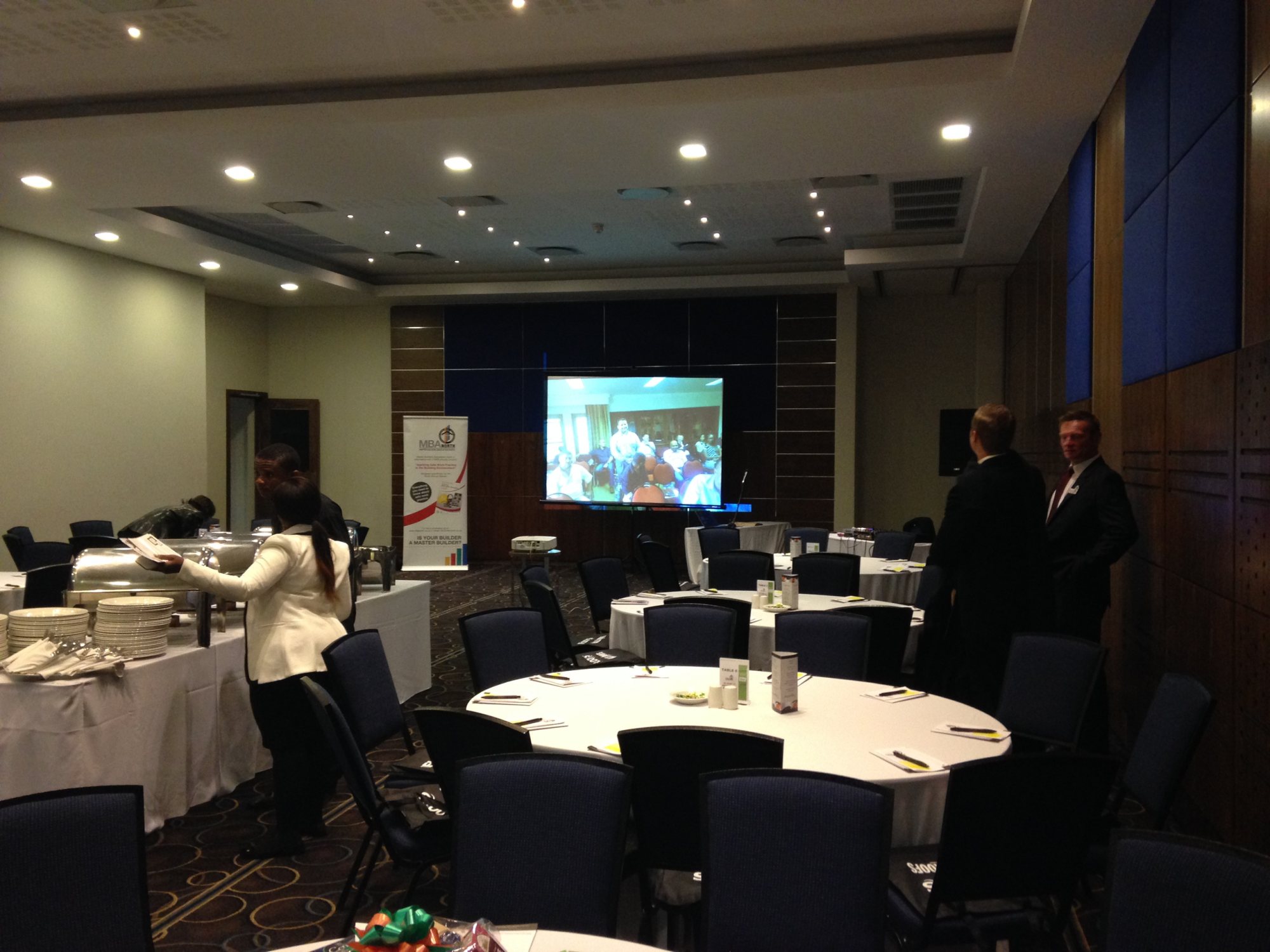 Interior event space with projector and tables set up
