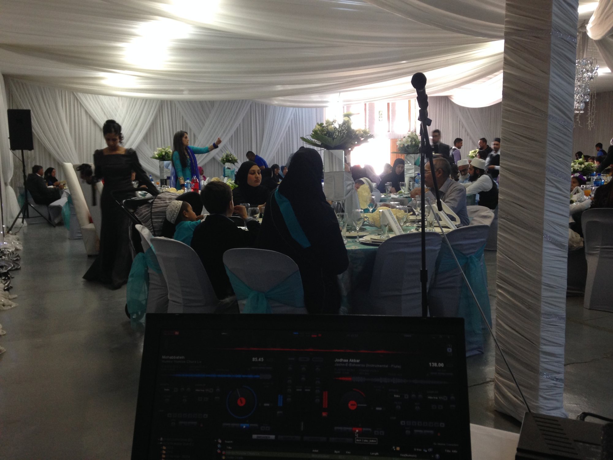 A DJ setup with guests enjoying an event.