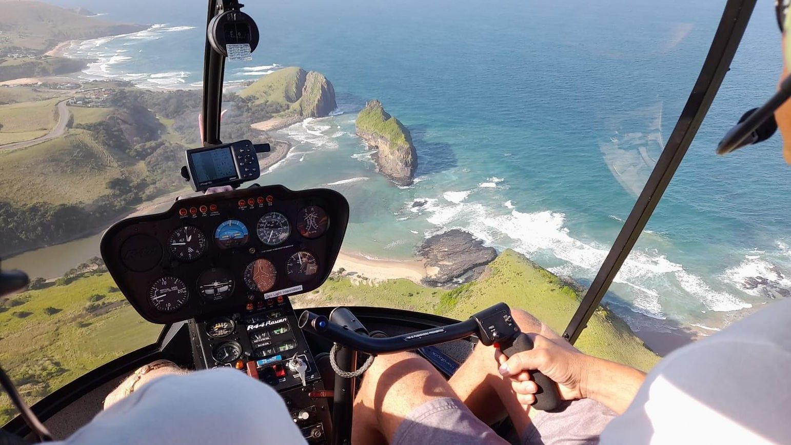 Aerial view from a helicopter over coastal scenery.