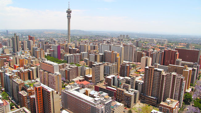 Aerial view of Johannesburg skyline with buildings and landmarks.