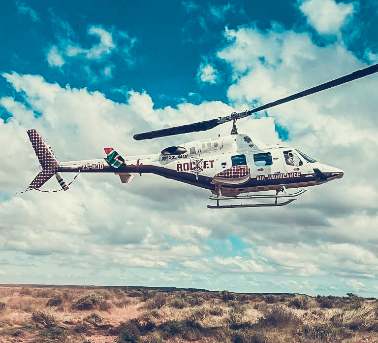Air ambulance helicopter in flight with medical branding