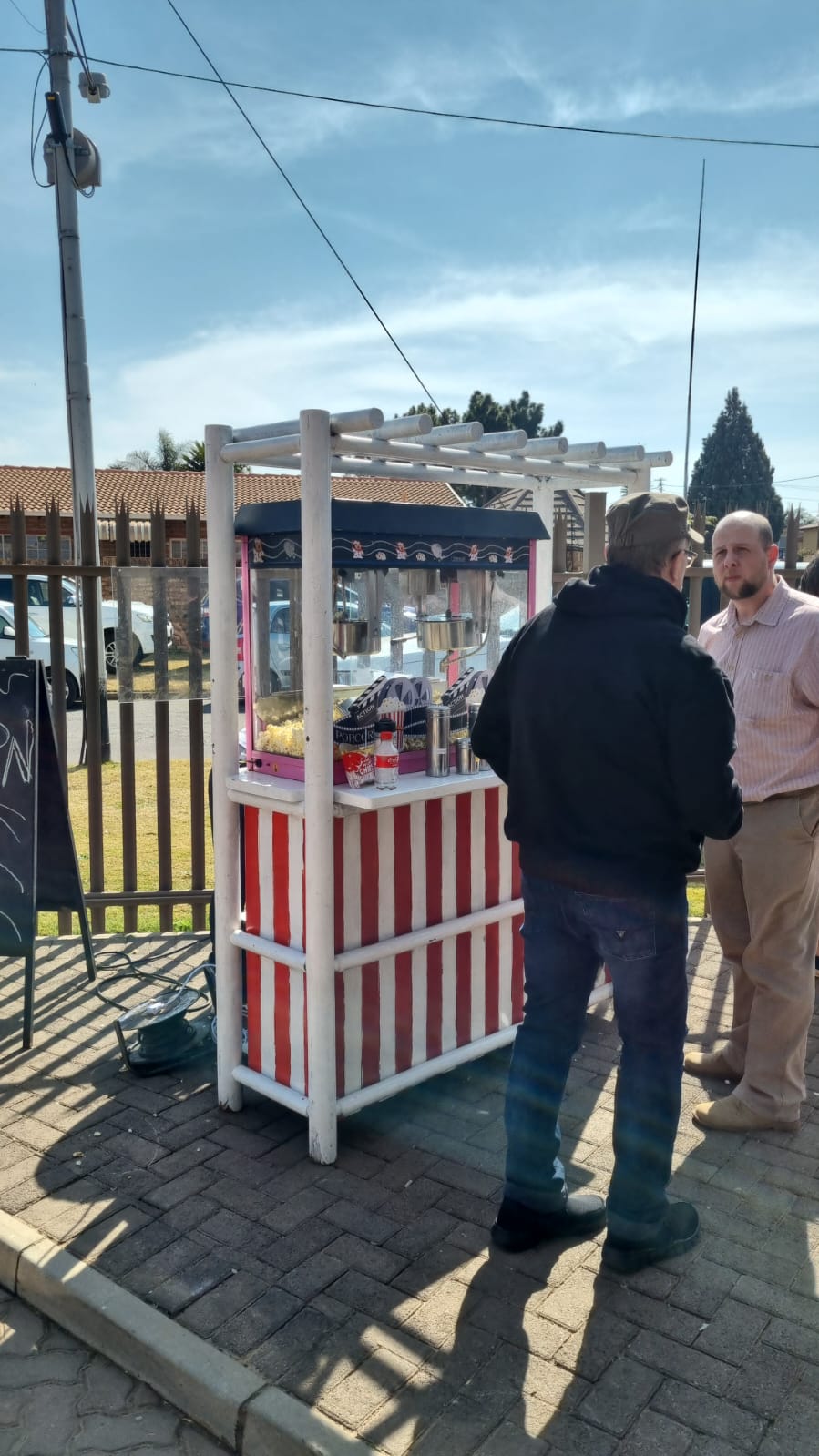 Popcorn stand with customers in front