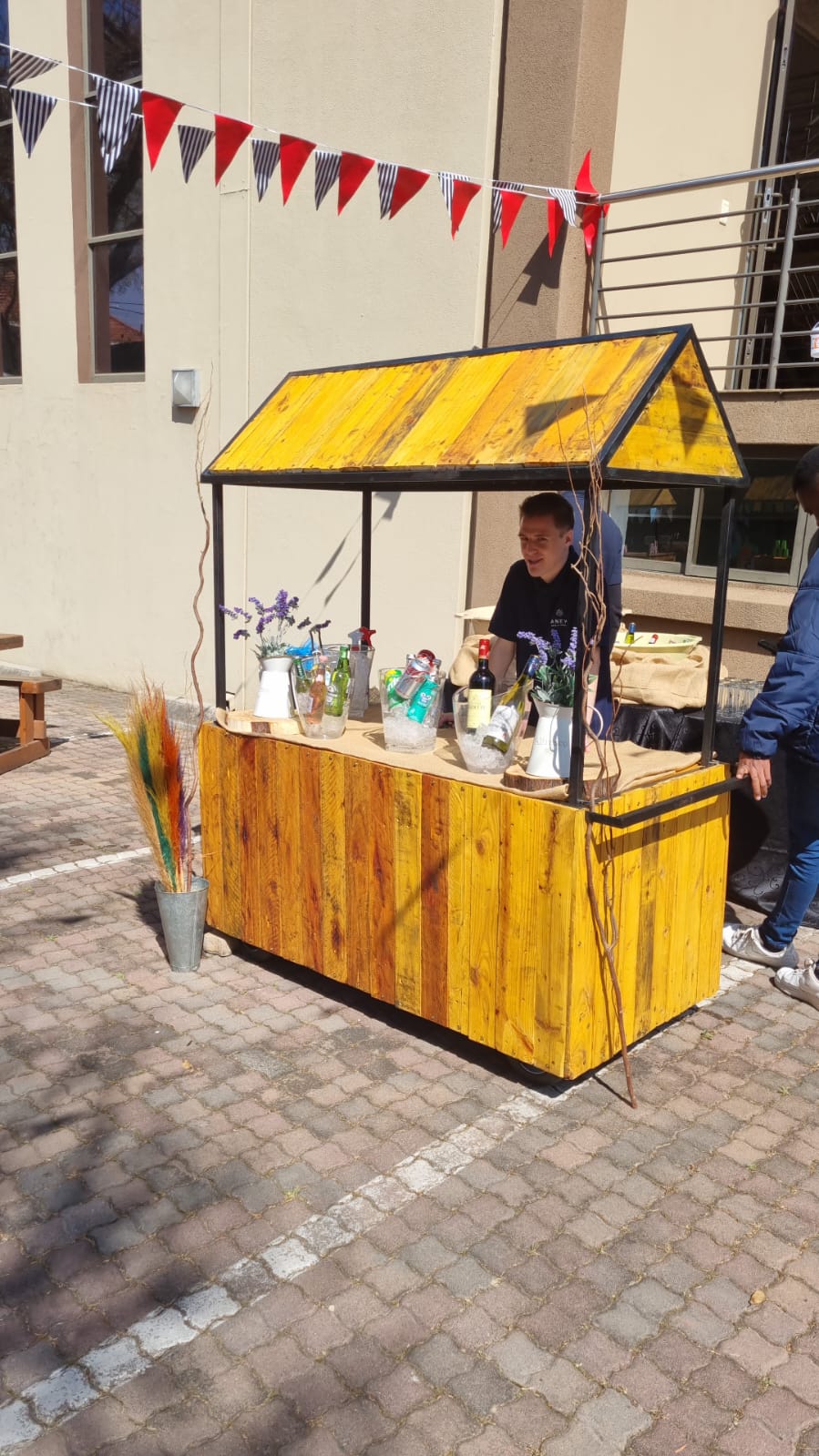 Brightly colored refreshment stand with drinks and decorations