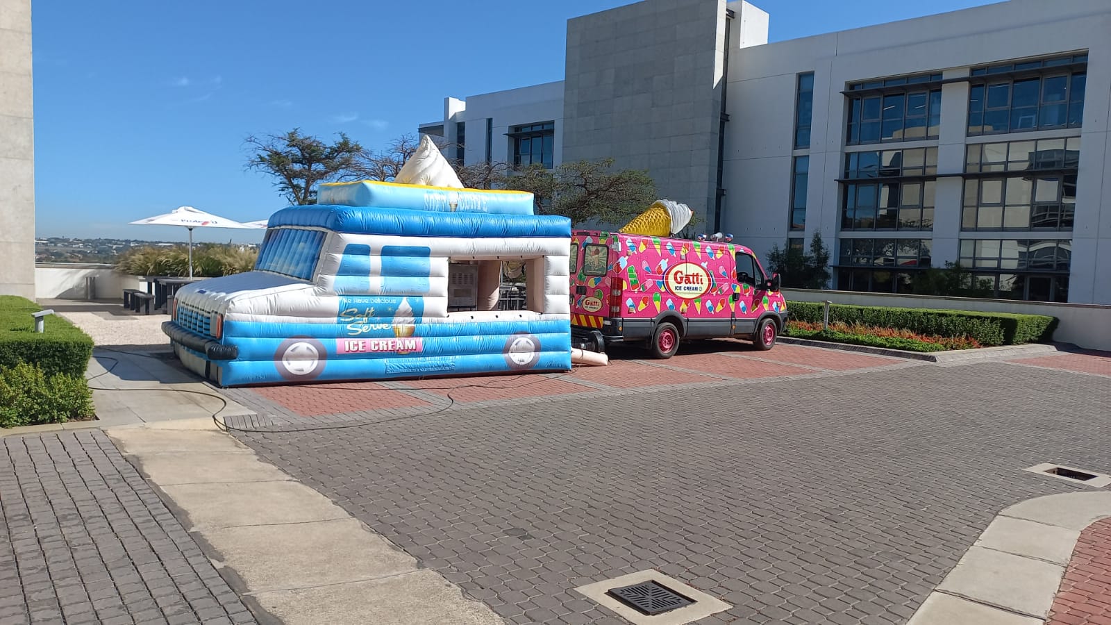 Inflatable ice cream truck next to a colorful ice cream vehicle.