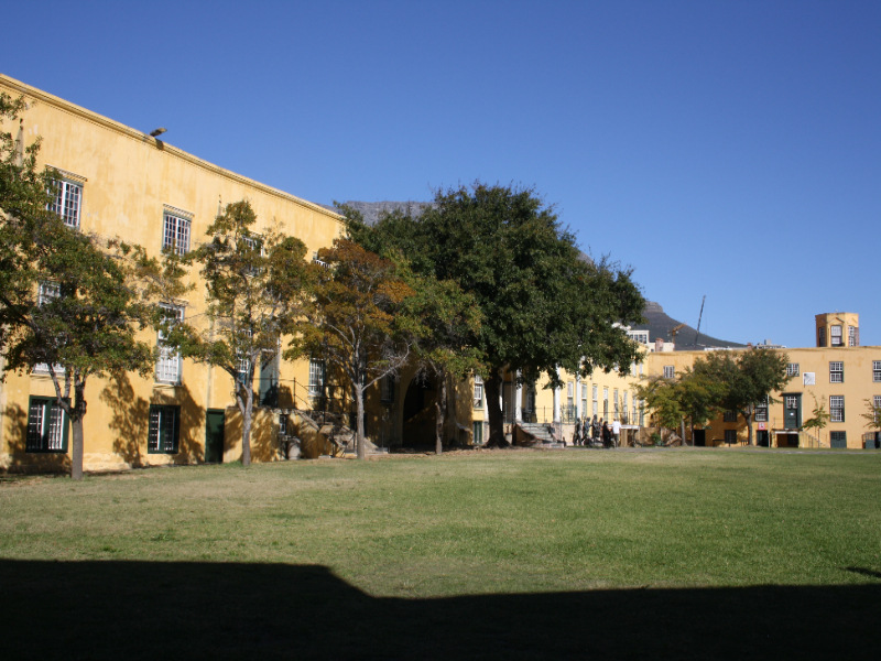 A view of the Castle of Good Hope's inner courtyard with surrounding buildings.