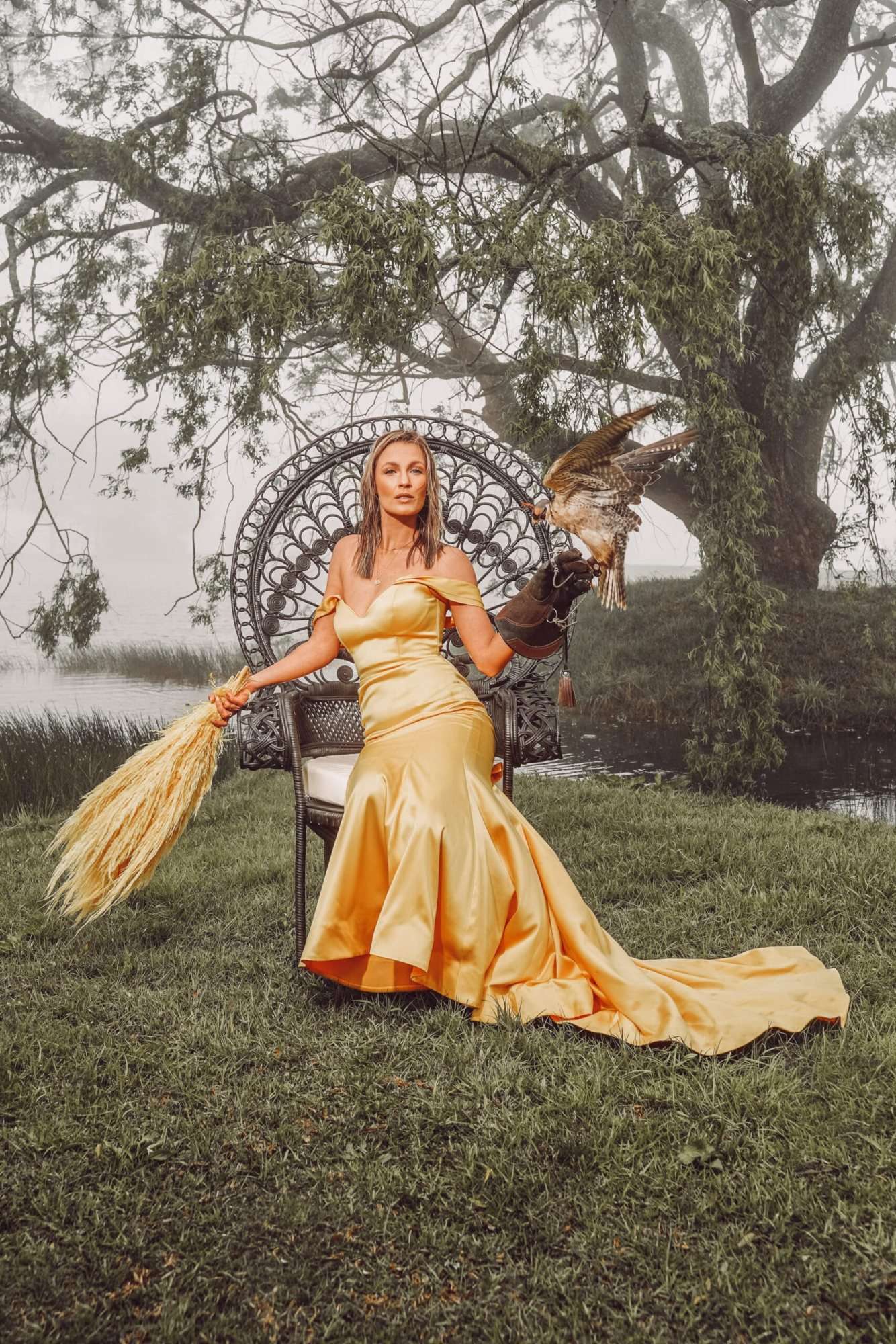 Woman in yellow gown seated in a Peacock Pose Emperor Chair outdoors
