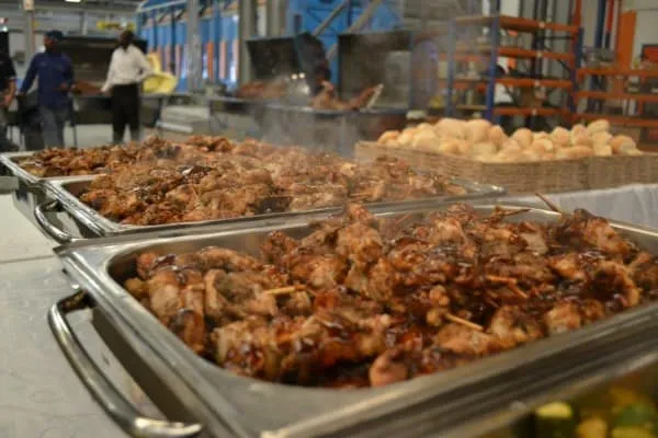 Buffet setup with grilled meats and rolls