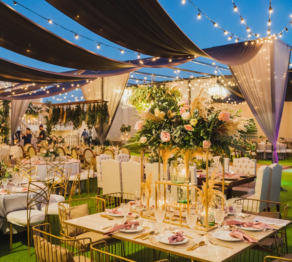 Elegant event decor setup with tables and floral arrangements.