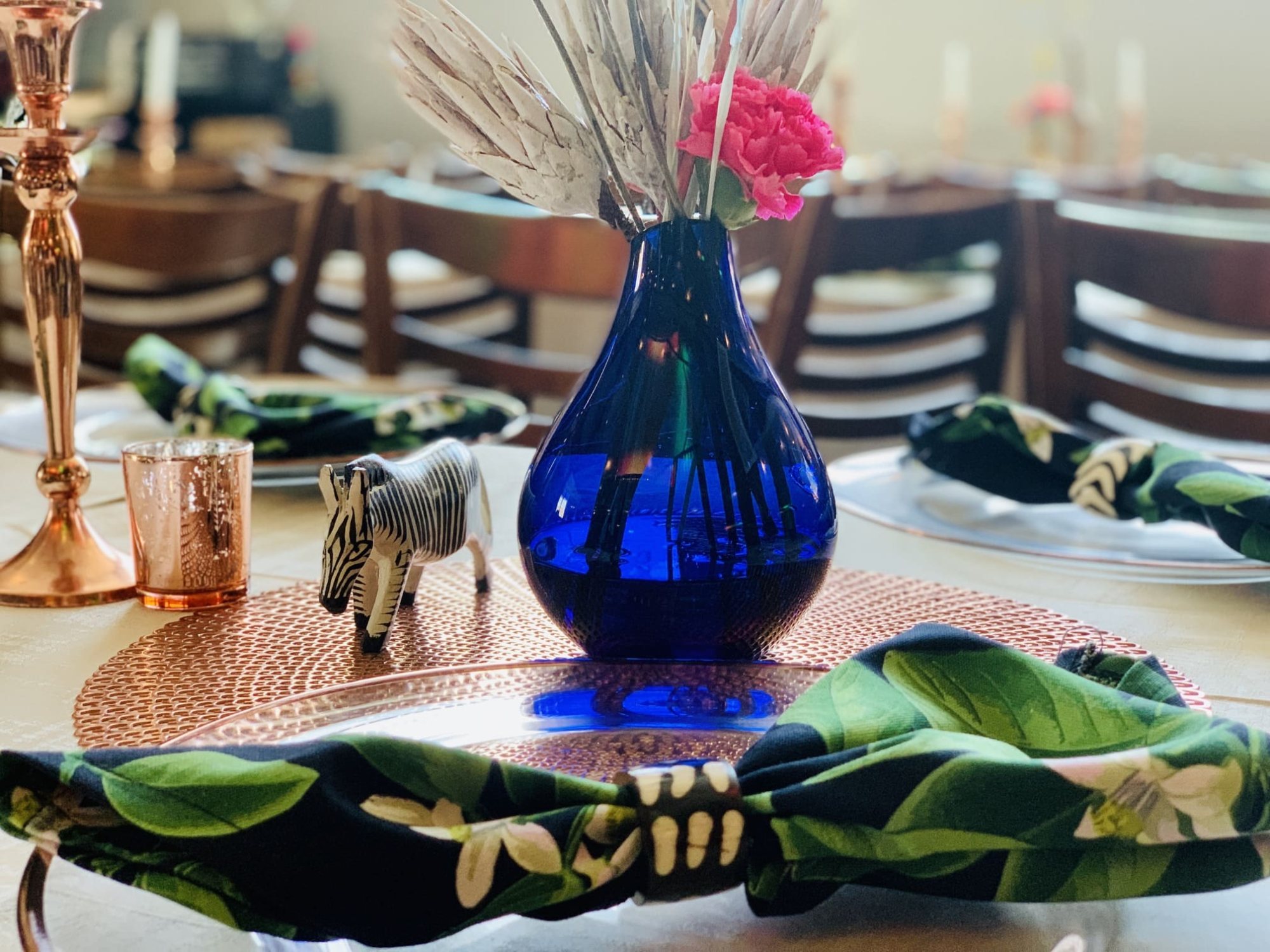 Stylish table setting with blue vase and patterned napkins
