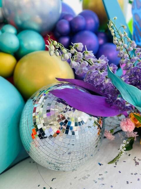 Decor arrangement with a disco ball and colorful spheres