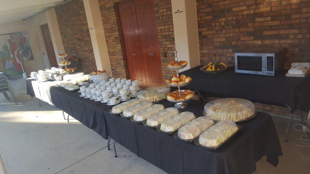 Buffet table with food and drinks setup for an event