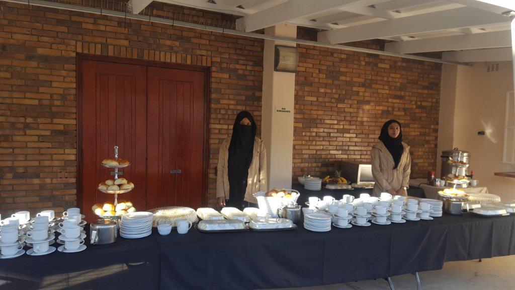 Catering station with Halaal food and two staff members