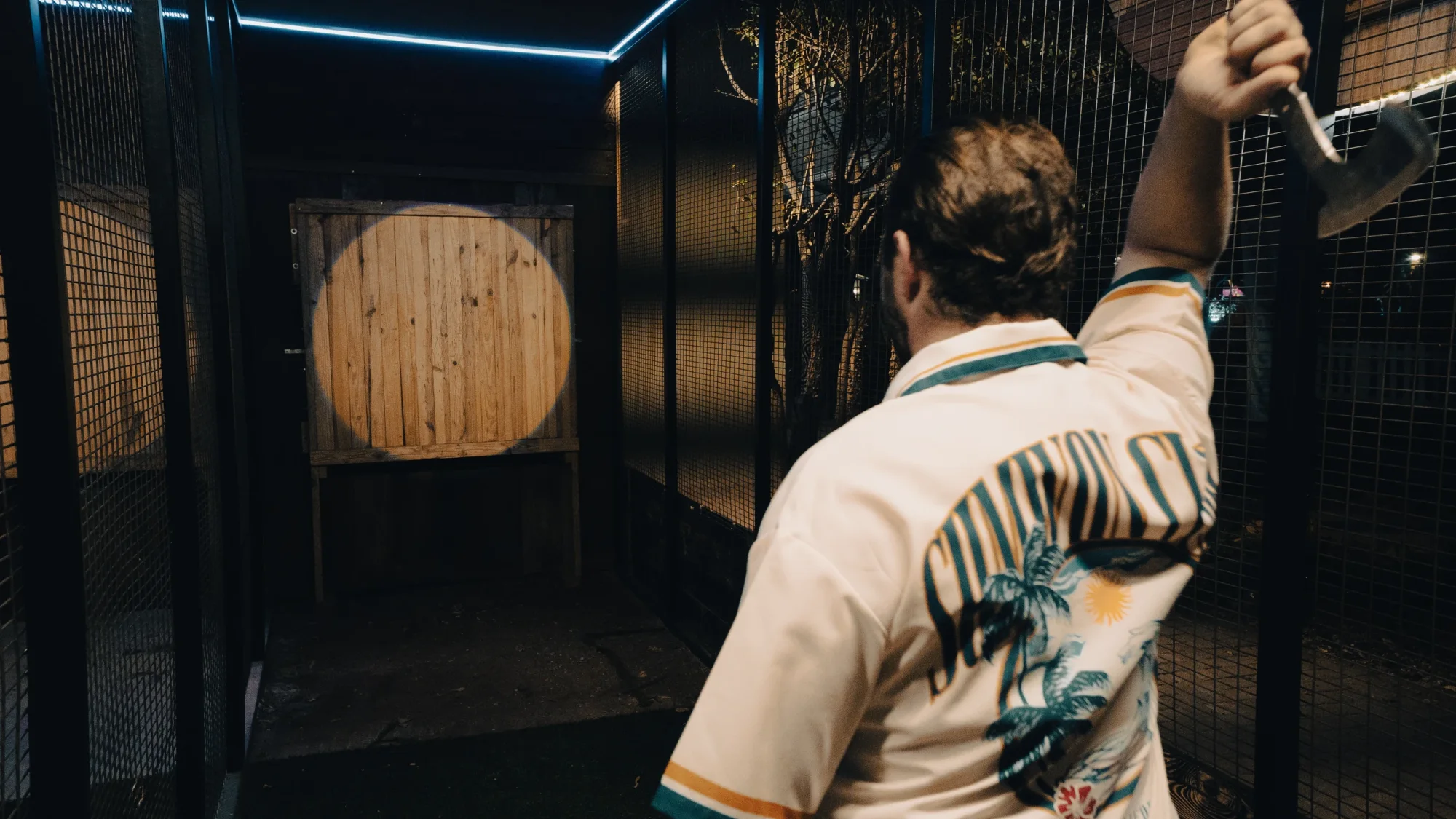 Participant about to throw an axe at a wooden target