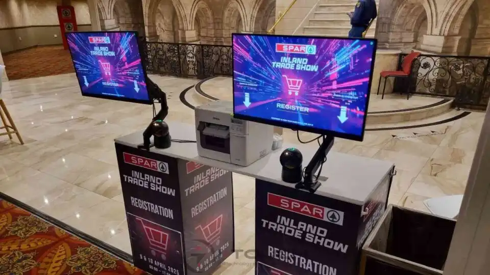 Sleek registration kiosks displaying event details and registration options.