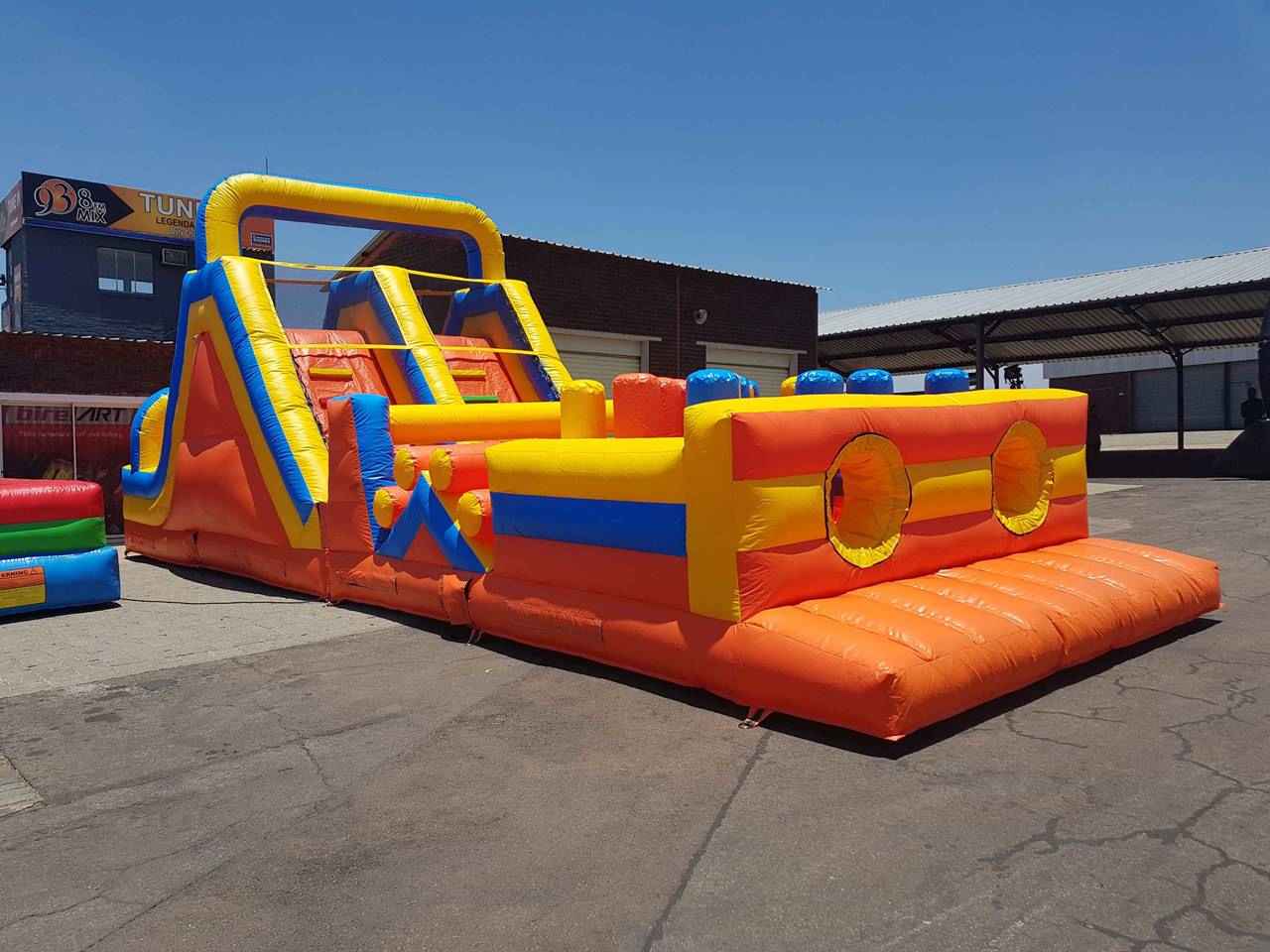 Multicolored inflatable obstacle course set up outdoors.
