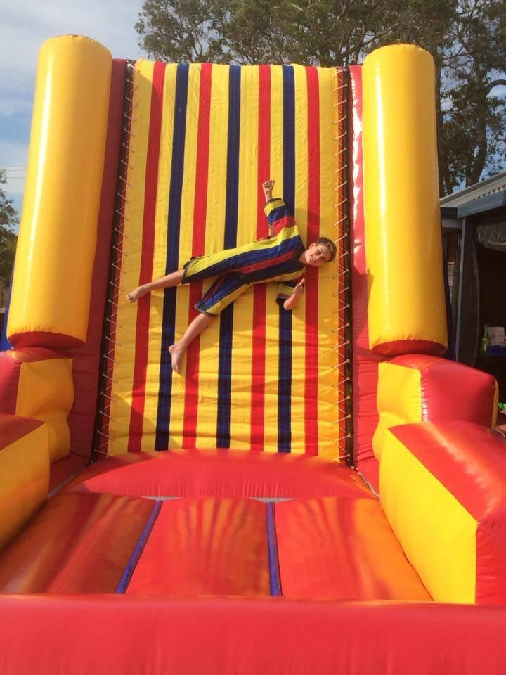 Child leaning on a colorful inflatable slide
