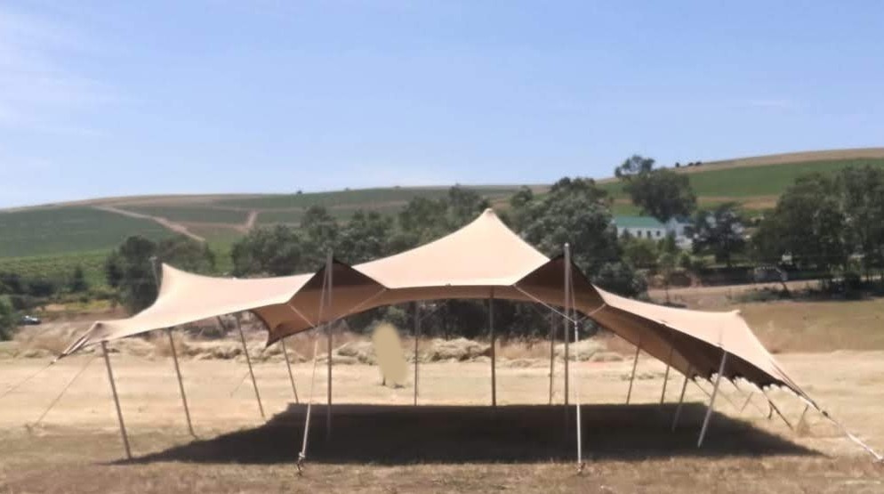 Stretch tent setup in a grassy outdoor area