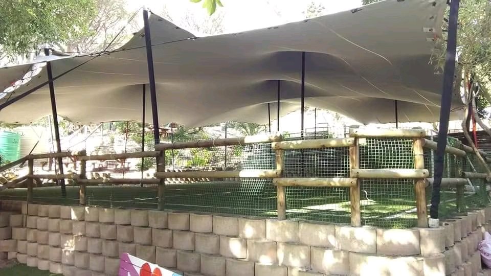A stretch tent setup providing shade in an outdoor area.