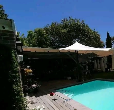 Outdoor stretch tent set up by a swimming pool