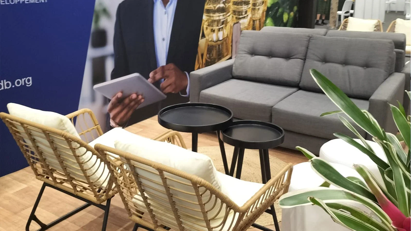 Modern lounge furniture with grey sofa and rattan chairs