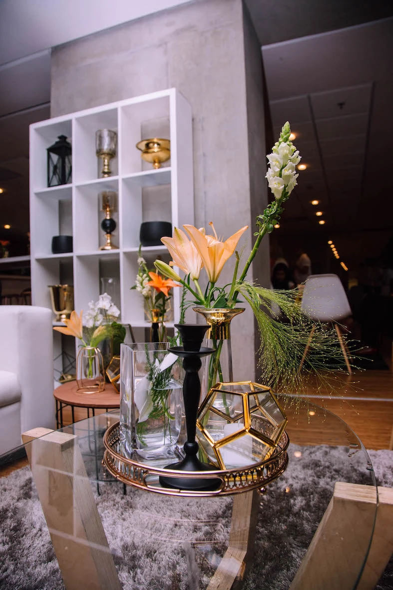 Table decor featuring flowers, vases, and decorative elements