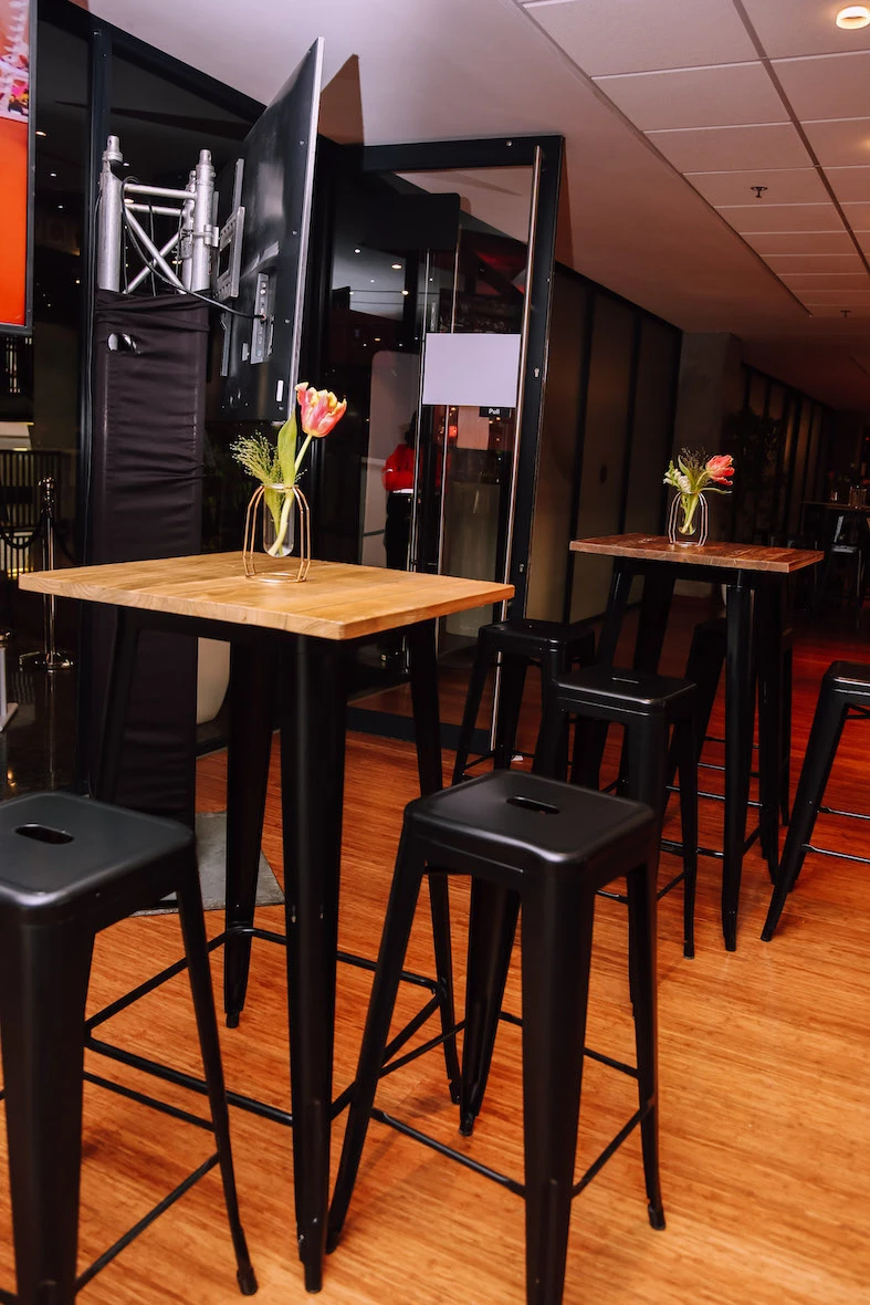 Bar table and stools with flowers in vases