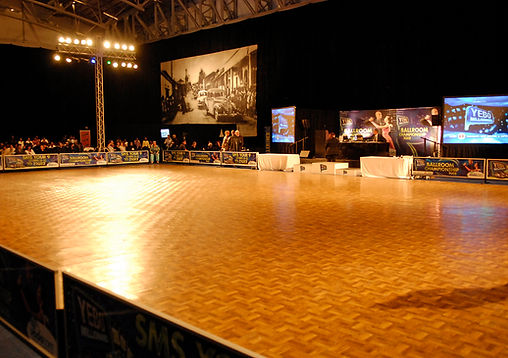 Large wooden dance floor set up in an event space.