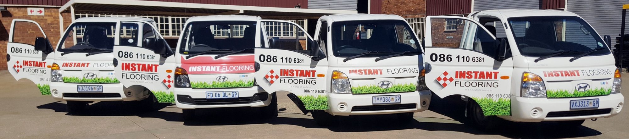 Four branded delivery vehicles from Instant Flooring