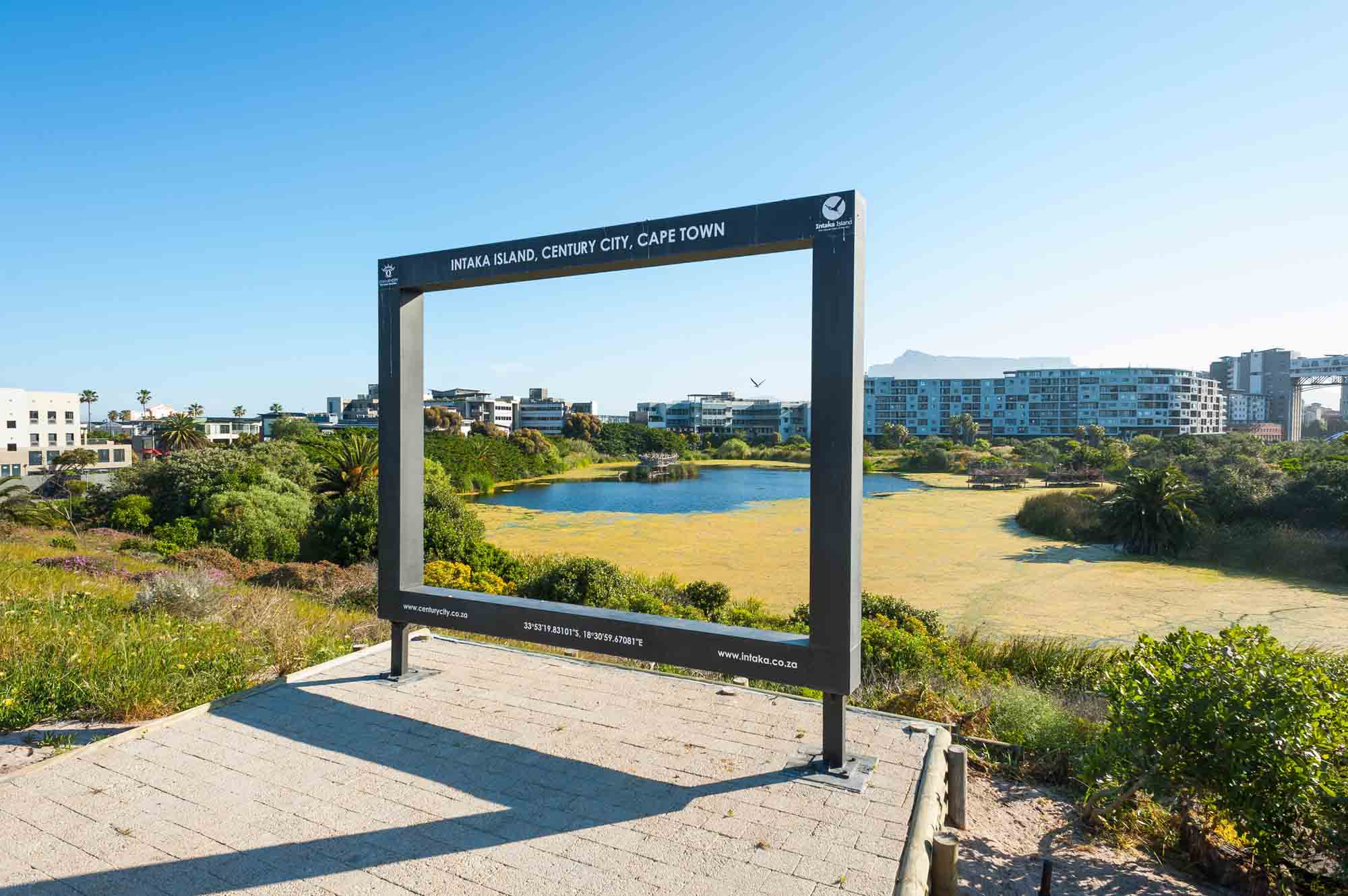 Photo frame at Intaka Island with wetland and buildings