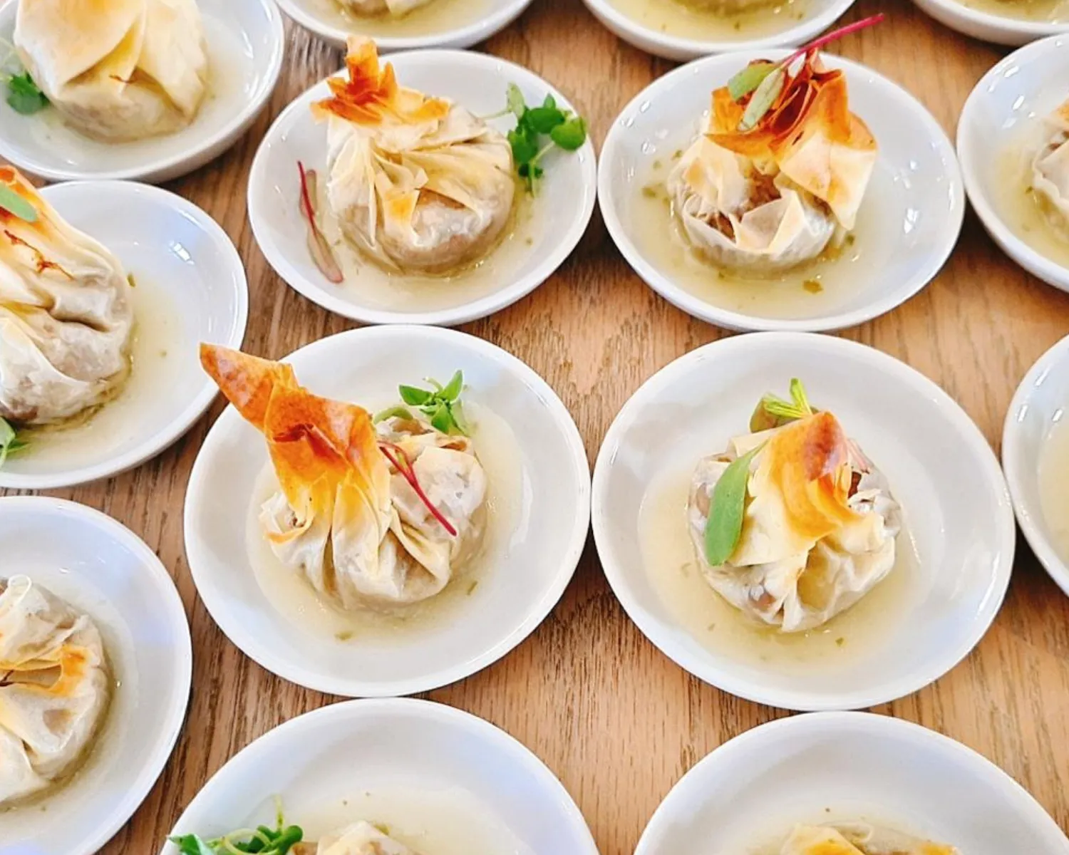 Plates with savory pastries garnished with herbs