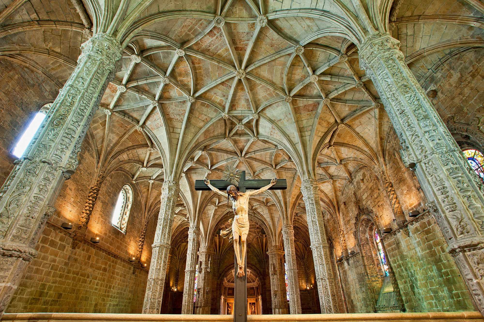 Interior view of a historical venue with tall arches and detailed stonework.