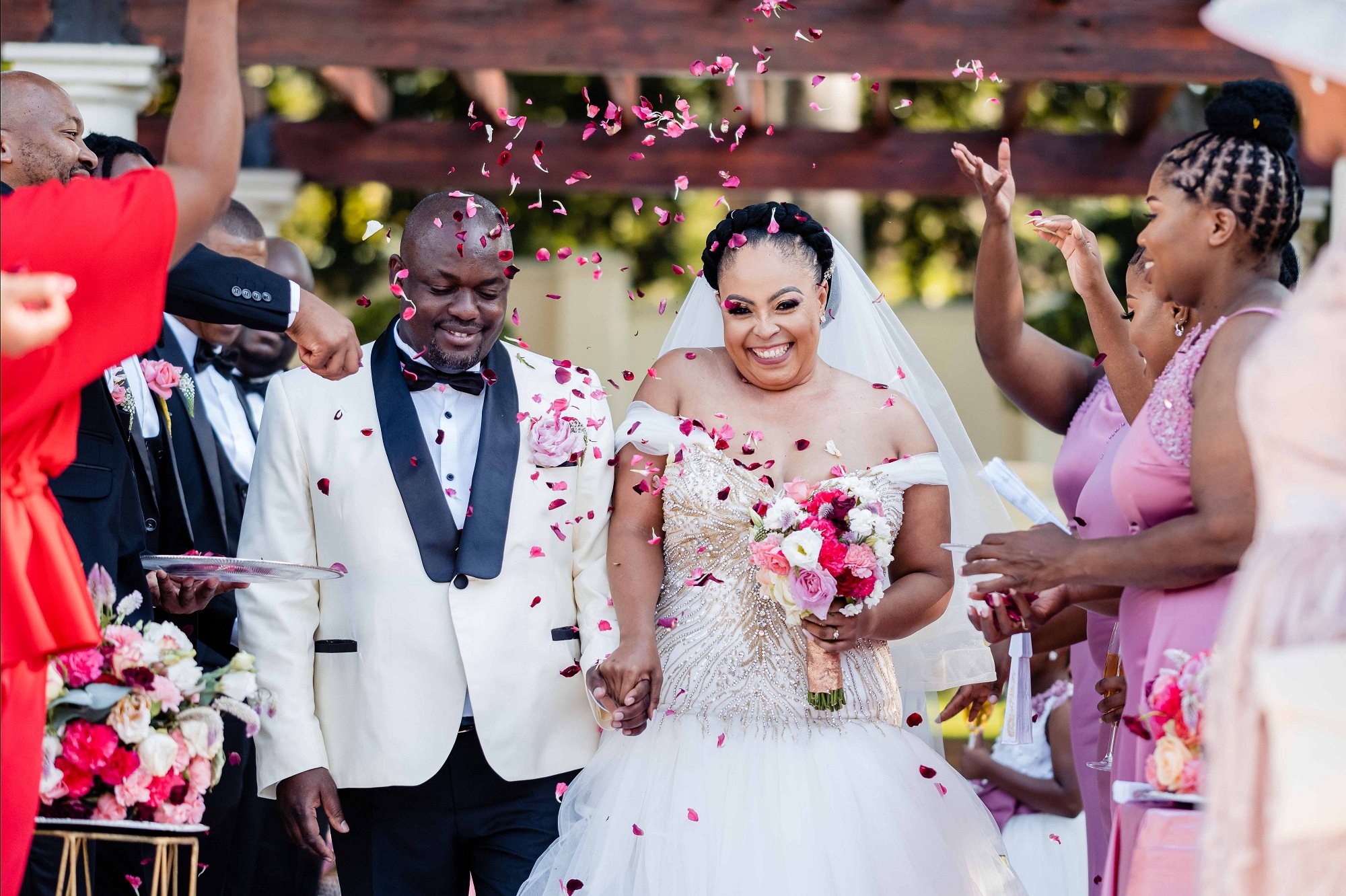 Newlyweds walking down the aisle with confetti.