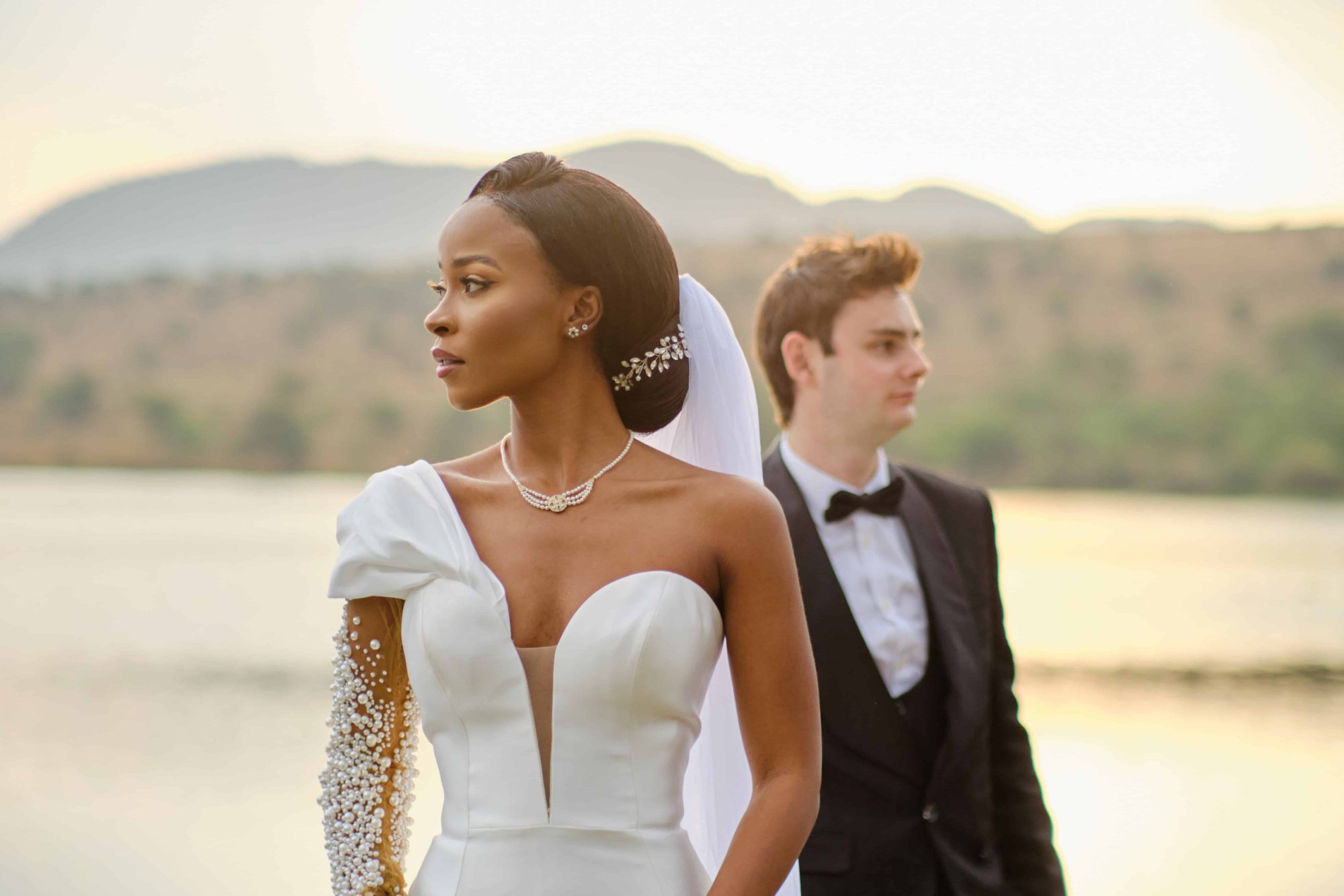 Bride and groom in a lakeside setting.