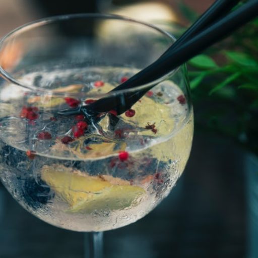 A close-up of a custom cocktail with garnish.
