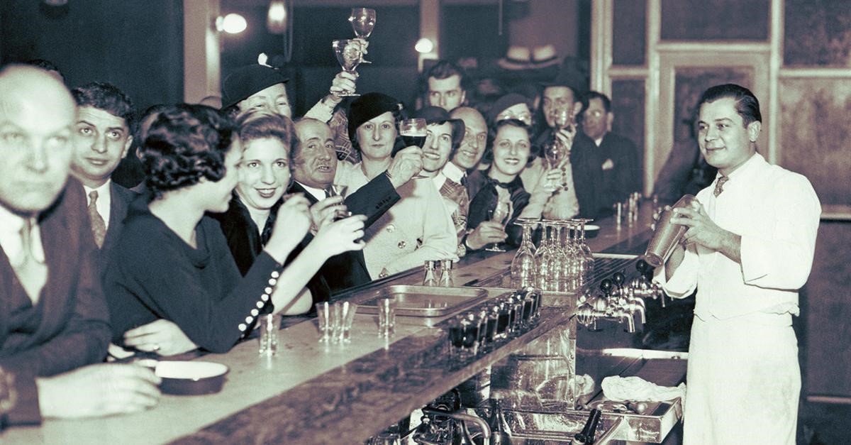Vintage bar scene with patrons raising glasses