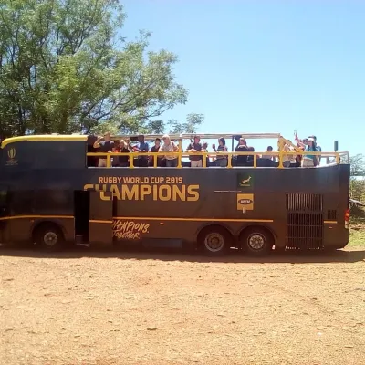 Open-top party bus featuring Rugby World Cup 2019 Champions branding.