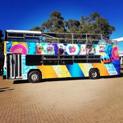 Colorful open top party bus parked and ready for events