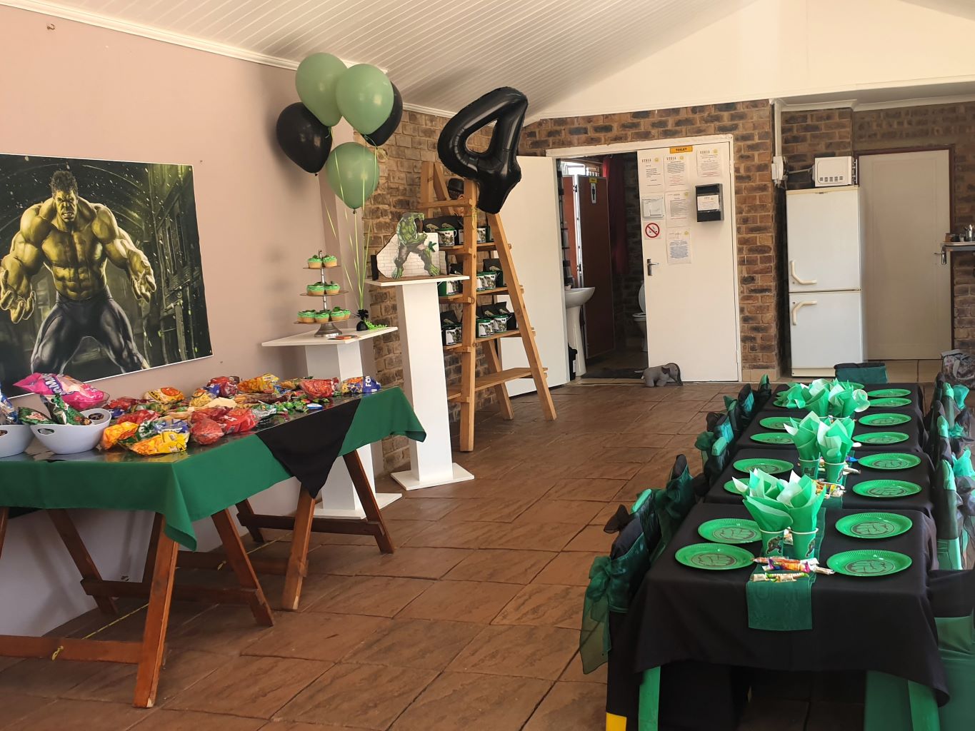 Themed party area with tables, party supplies, and decorations