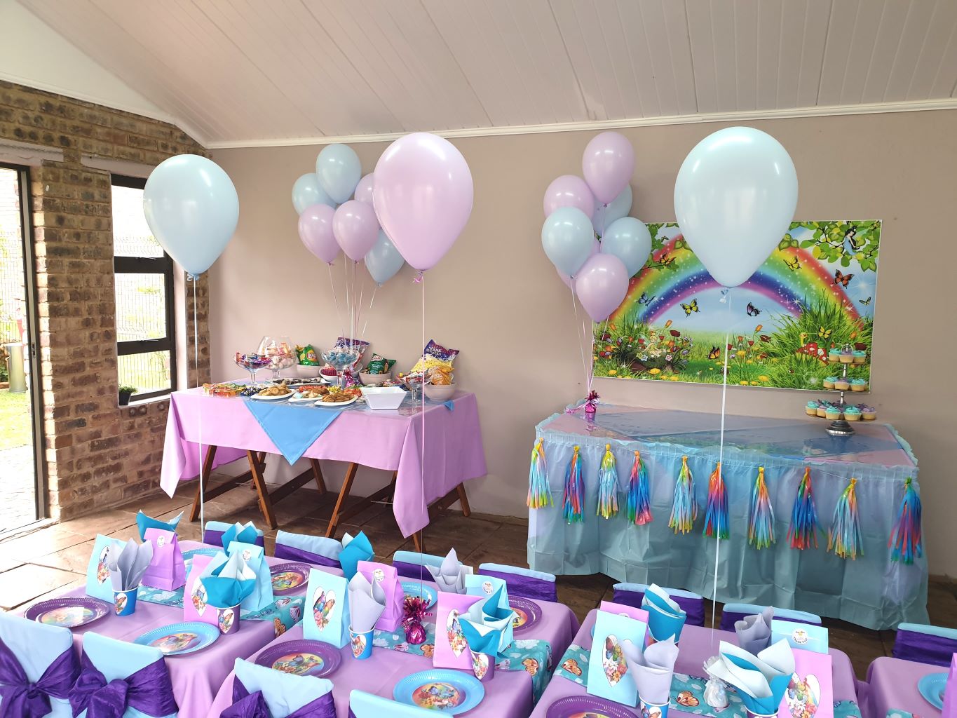 Colorful kids party table with balloons and treats