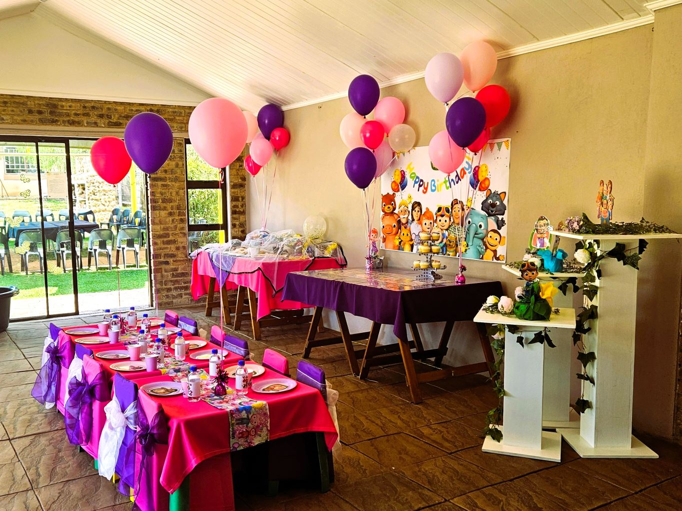Decorated party room with balloons and festive tables