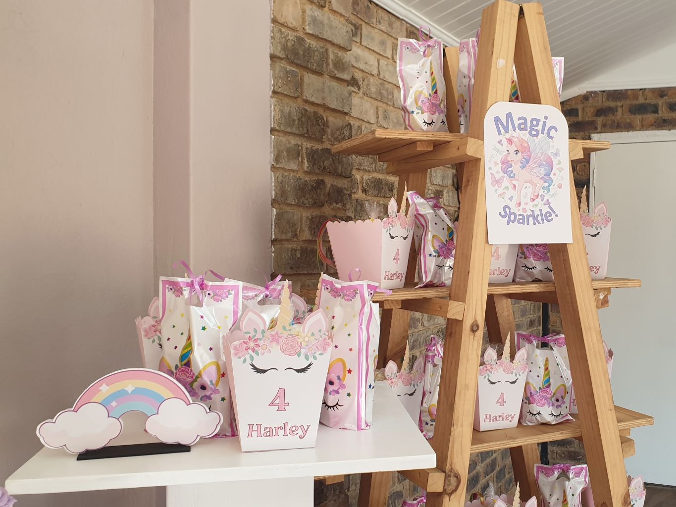 Colorful unicorn-themed party favor bags on display