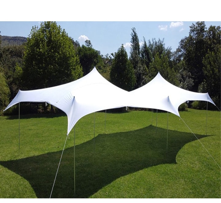 Two white stretch tents on a grassy area