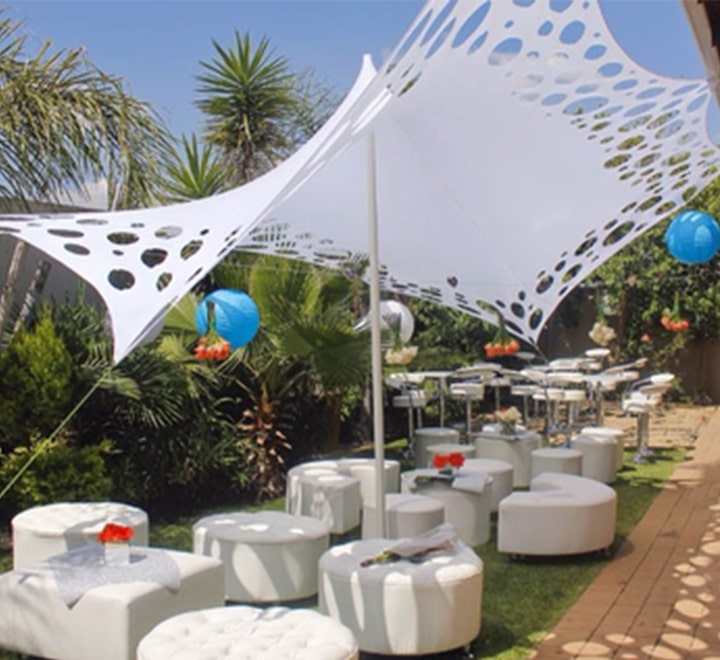 Outdoor event setup with a white canopy and seating.