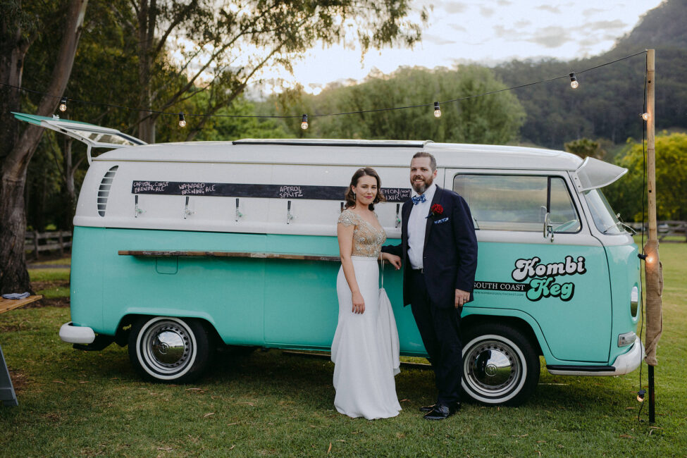 Couple posing next to a vintage VW Kombi bar