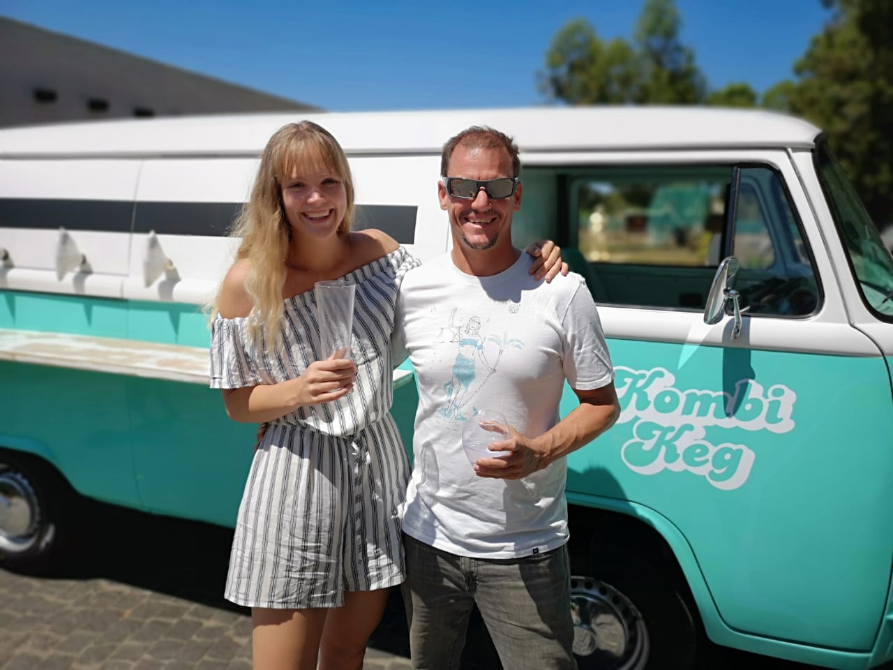 Couple standing beside a vintage VW Kombi bar