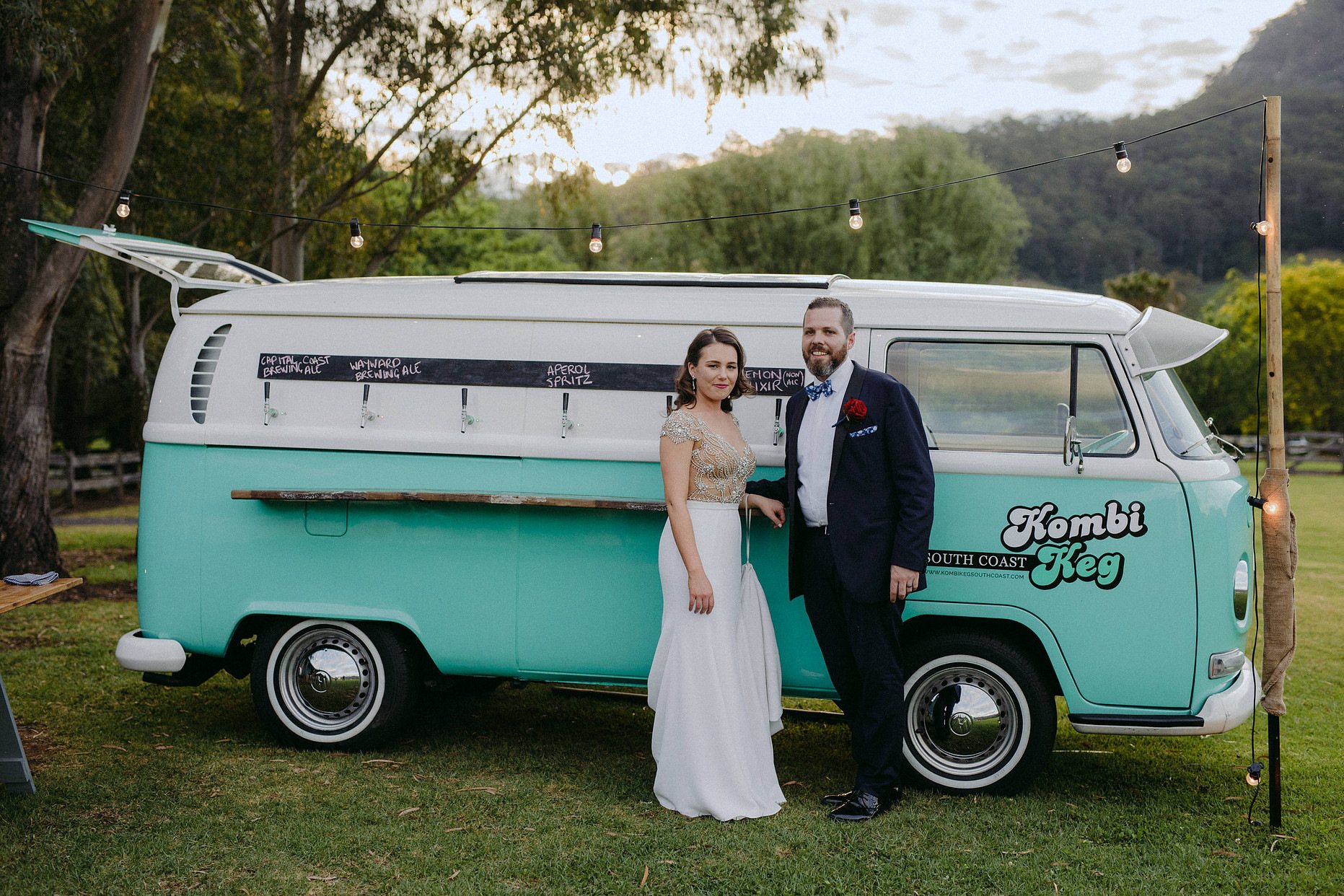 A vintage VW Kombi bar with two people in formal attire.