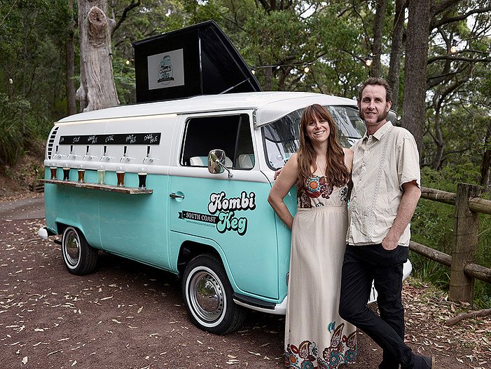Vintage VW Kombi mobile bar with couple beside it