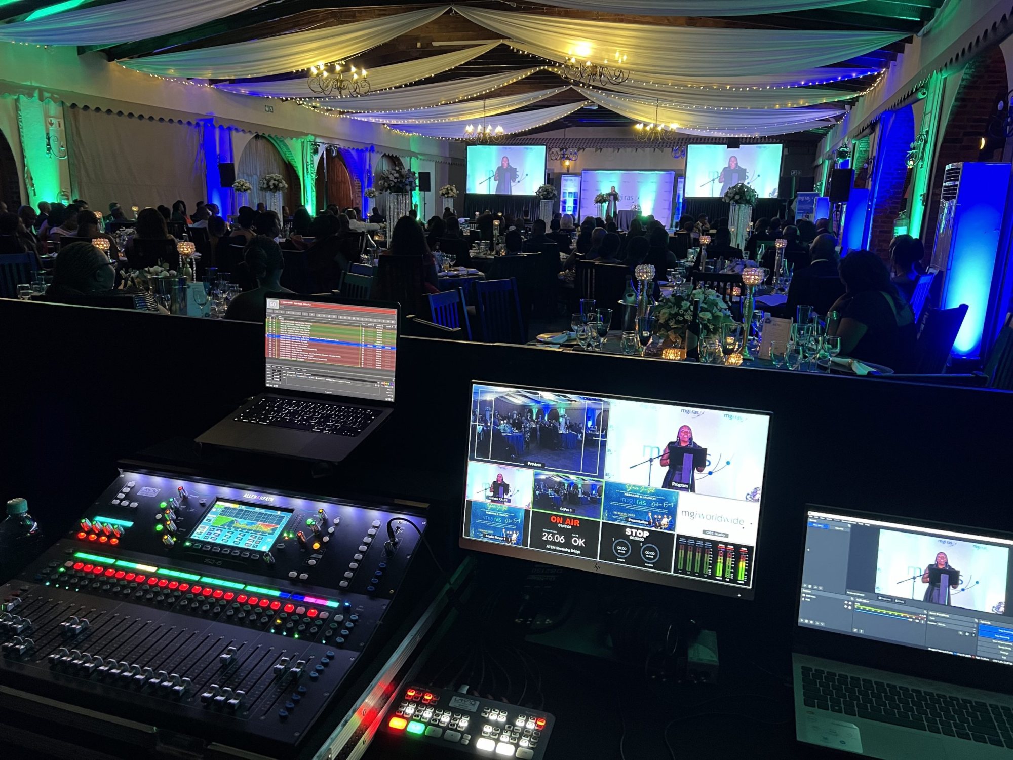 AV control booth featuring sound and visual equipment at an event.
