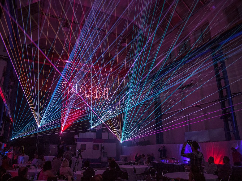 Colorful laser beams illuminating an indoor venue