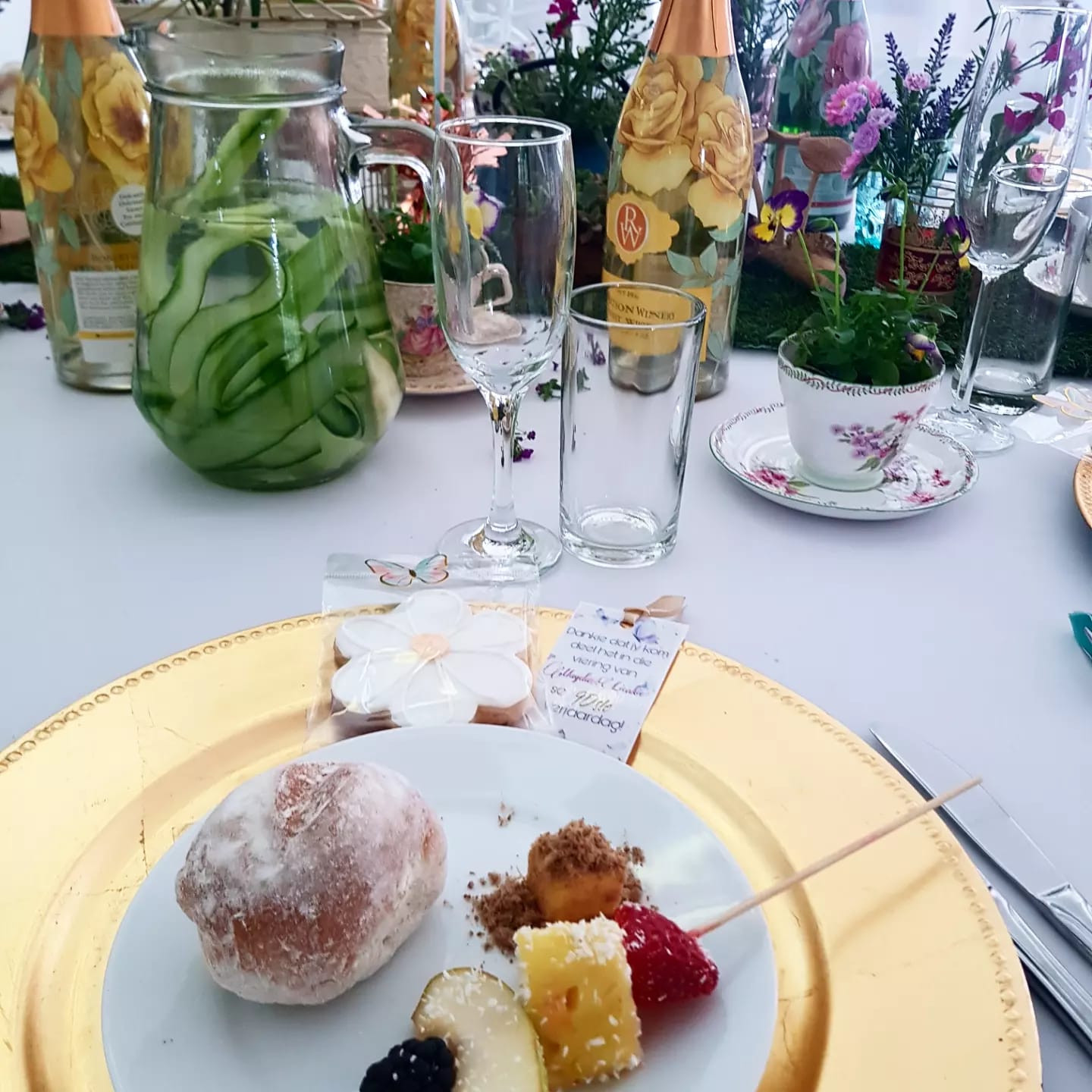 Plate with assorted desserts and drinks on a decorated table